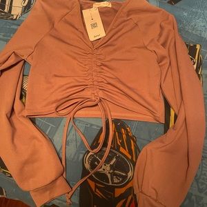 a sweater/shirt, that is synched in the front and ties